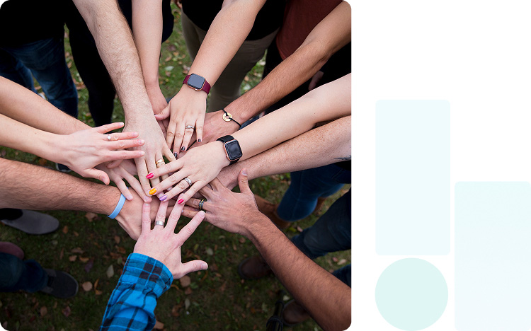 Almost a dozen arms stretched with hands all in a circle